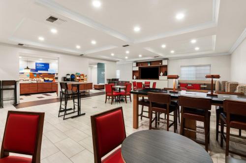 a large room with tables and chairs and a kitchen at Holiday Inn Express Hotel & Suites Klamath Falls Central, an IHG Hotel in Klamath Falls