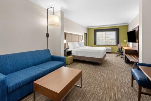 a hotel room with a bed and a couch at Holiday Inn Express Hotel & Suites Klamath Falls Central, an IHG Hotel in Klamath Falls
