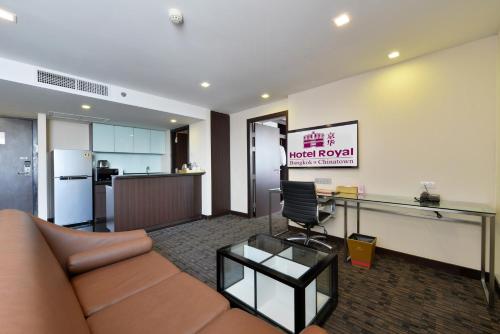an office with a couch and a desk and a kitchen at Hotel Royal Bangkok in Bangkok