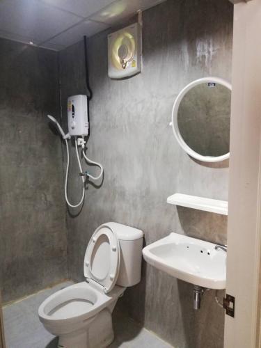 a bathroom with a toilet and a sink and a mirror at Banrimkhao pakchong in Pak Chong