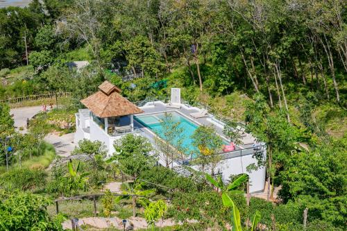 an aerial view of a house with a swimming pool at Purana Resort Koh Yao Noi - SHA Extra plus in Ko Yao Noi