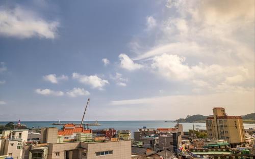a view of a city with the ocean in the background at GijangYeonhwari No,25 Hotel in Busan