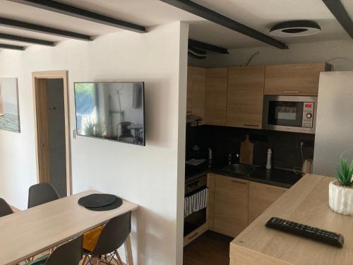 a kitchen with a table and a counter top at Retro chaty Soběšky in Horní Soběšovice