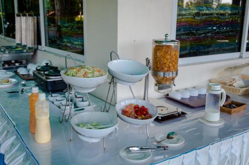 a buffet with bowls of food on a counter at The RiverKwai Bridge Resort in Kanchanaburi City
