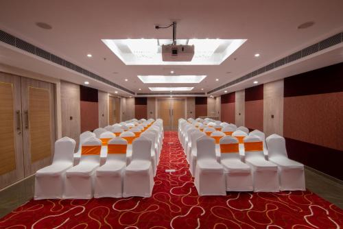 a room with a row of white chairs in a room at Howard Johnson by Wyndham, Kolkata Airport in Kolkata