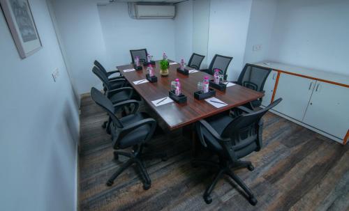 a conference room with a long wooden table and chairs at Howard Johnson by Wyndham, Kolkata Airport in Kolkata