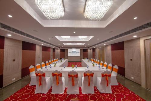 a conference room with a long table with orange bows at Howard Johnson by Wyndham, Kolkata Airport in Kolkata