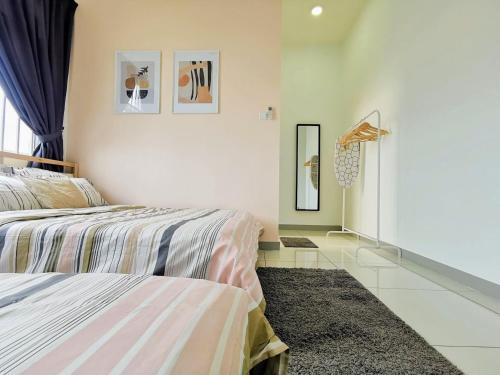 a bedroom with two beds and a mirror on the wall at Skypod Residence Puchong in Puchong