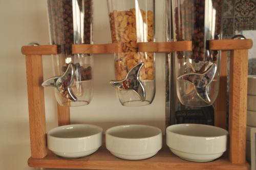 a wooden shelf with three bowls and a pitcher at Lapis Inn Hotel & Spa ( Ex. Ambassador Hotel) in Istanbul