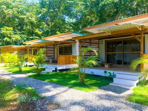 a house with a porch and a yard at Sonora Jungle & Yoga Retreat in Puerto Viejo