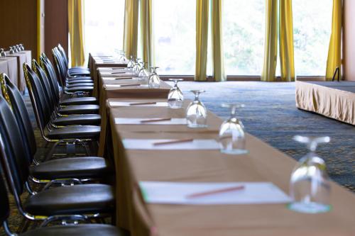 a row of tables and chairs in a room at Jazzotel Bangkok in Bangkok