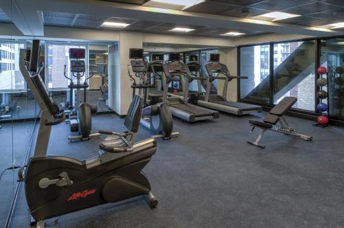 a gym with treadmills and ellipticals in a building at Godfrey Hotel Chicago in Chicago