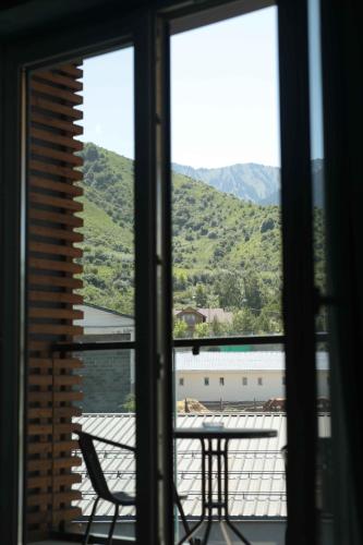 a view from a window of a table and mountains at Гостиничный комплекс Be Fine in Besqaynar