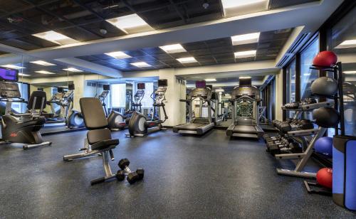 a gym with several treadmills and cardio machines at Godfrey Hotel Chicago in Chicago