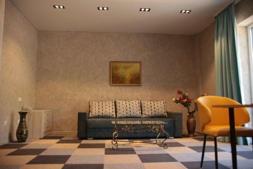 a living room with a couch and a table at Гостиничный комплекс Be Fine in Besqaynar