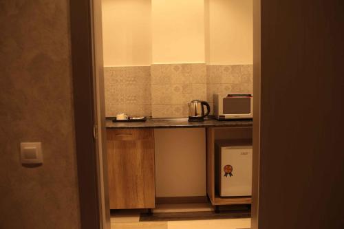 a kitchen with a counter top with a microwave at Гостиничный комплекс Be Fine in Besqaynar