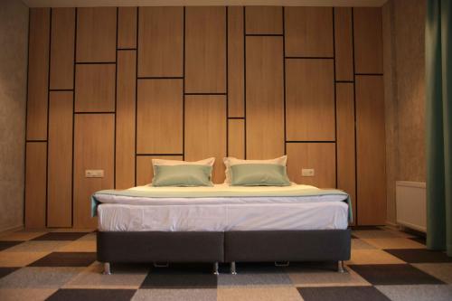 a bed with two pillows on it in a room at Гостиничный комплекс Be Fine in Besqaynar