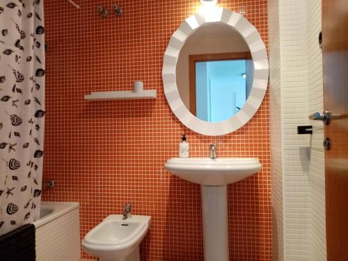 a bathroom with a sink and a mirror at El remanso II in La Manga del Mar Menor