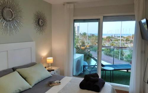 a bedroom with a bed and a view of a balcony at El remanso II in La Manga del Mar Menor