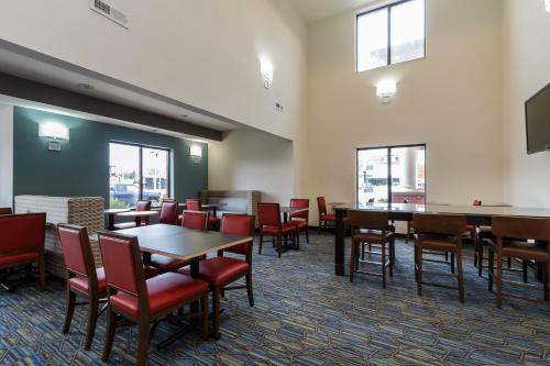a dining room with tables and chairs and windows at Holiday Inn Express & Suites - South Bend - Notre Dame Univ. in South Bend