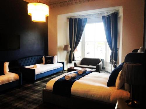 a hotel room with two beds and a television at Edinburgh Lodge West End in Edinburgh