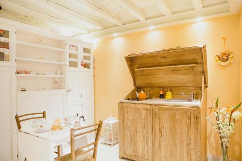 a kitchen with a sink and a table at La Casa degli Uccellini in Lucca