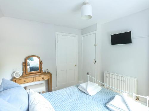 a bedroom with a bed and a mirror at Elm Villa in Wareham
