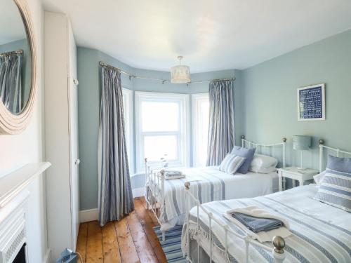 a bedroom with two beds and a window at Elm Villa in Wareham