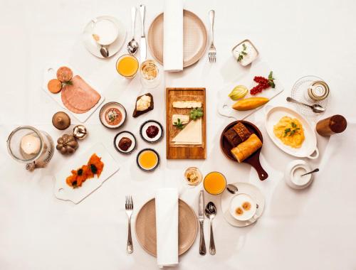 a table with plates of breakfast food on it at Landhaus Halferschenke in Dieblich