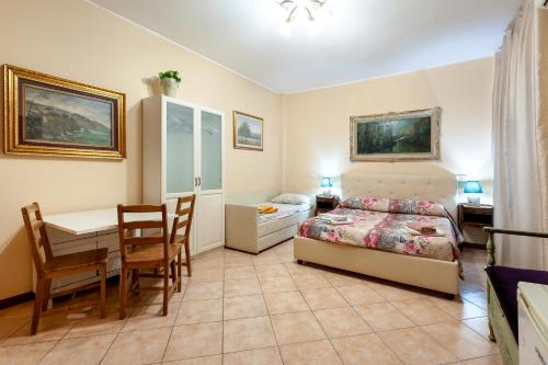 a bedroom with a bed and a table and a desk at Vatican Mami in Rome