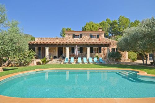 a house with a swimming pool in front of a house at Cocons in Sineu
