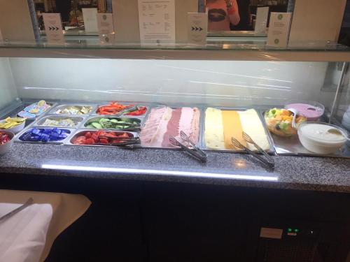 a refrigerator filled with different types of food at Hotel Donaustadt Kagran - at Metro U1 in Vienna