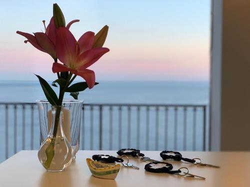 a vase with a flower in it on a table at Villa Le Baste in Furore