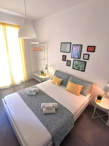 a bedroom with a large bed with towels on it at Casa Pirri in Palermo