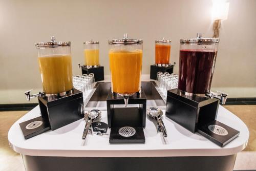 a table with three different types of drinks in glasses at Grand Mogador City Center in Casablanca