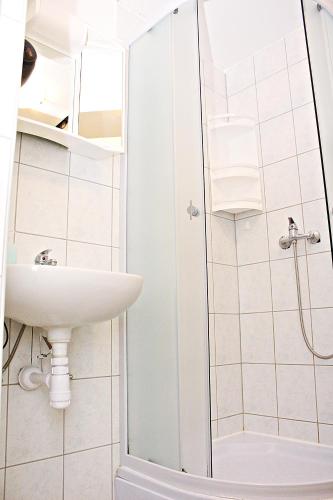 a bathroom with a sink and a shower at Studio Apartman Zara in Zadar