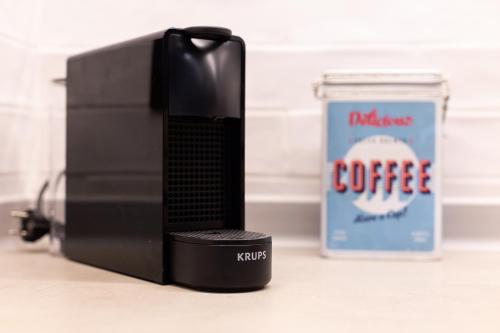 a coffee machine next to a container of coffee at ART LOFTS Valencia by Benisur in Valencia