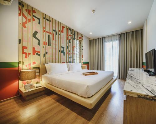 Postel nebo postele na pokoji v ubytování The Peri Hotel Khao Yai