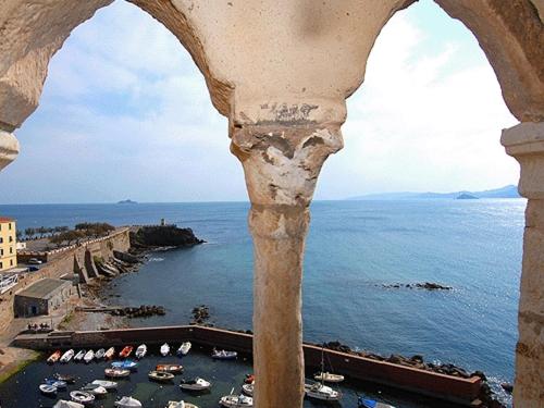 a view of a harbor from a building with boats in the water at Tre Orologi in Piombino
