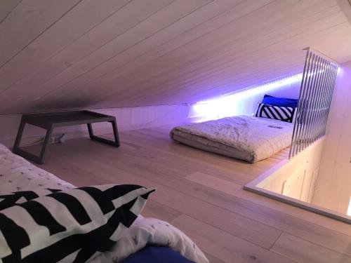 a bedroom with two beds in a attic at Hytte med sjøutsikt og 20 min fra dyreparken in Grimstad