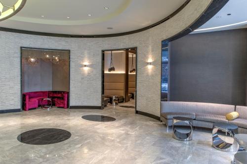 a lobby with a couch and chairs and a mirror at Godfrey Hotel Chicago in Chicago