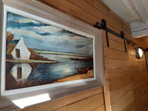 a painting of a painting of a boat on a wall at La petite Juliette in Leuze-en-Hainaut