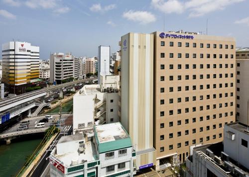 a view of a city with buildings and a river at Daiwa Roynet Hotel Okinawa-Kenchomae in Naha