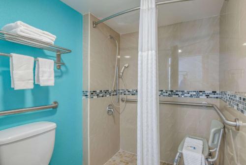 a bathroom with a shower and a toilet at Rodeway Inn Port Richey North in Port Richey