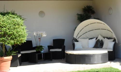 a living room with a couch and a chair at Hotel Pension Verdorfer in Merano