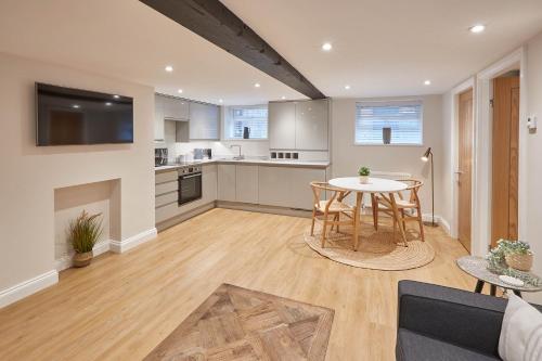 a kitchen and living room with a table and chairs at Host & Stay - Staffordshire Hideaway in Whitby