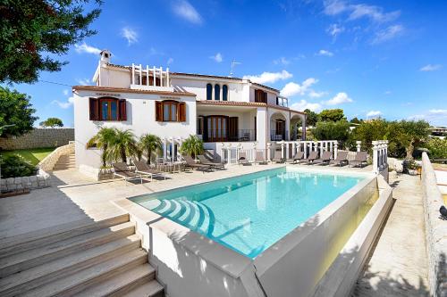 una villa con piscina di fronte a una casa di Villa Domus Petraianca a Marina di Ragusa