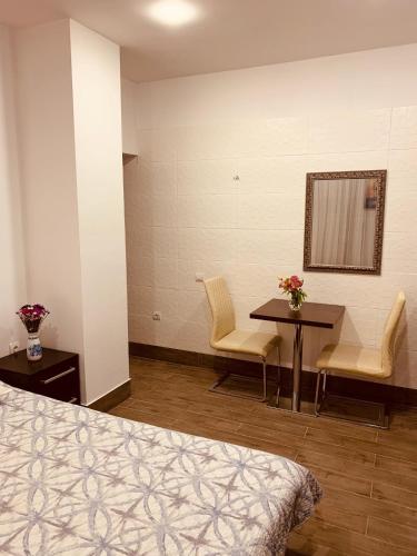 a hospital room with a bed and a table and chairs at WINE & ROSE BOUTIQUE HOTEL in Kharkiv