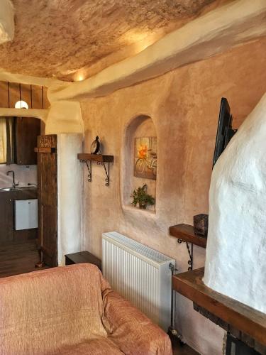 a living room with a bed and a kitchen at Anilia Guesthouse in Synikia Mesi Trikalon