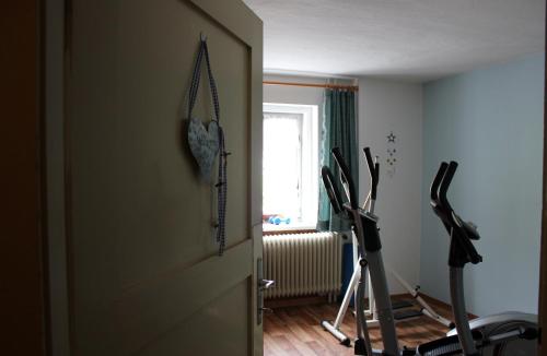 a room with two exercise bikes and a door at Pension Leitner in Hofen